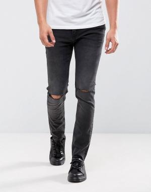 Черные облегающие джинсы с рваными коленями Cheap Monday. Цвет: черный