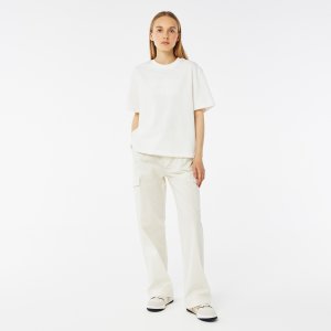 Брюки и шорты Женские Lacoste. Цвет: белвый